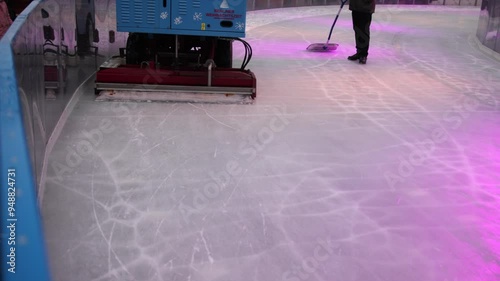 Smooth Ice, Wintery Scene, Snow Removal. Rink is brightened by lively lights as ice resurfacer navigates through scattered snow. photo