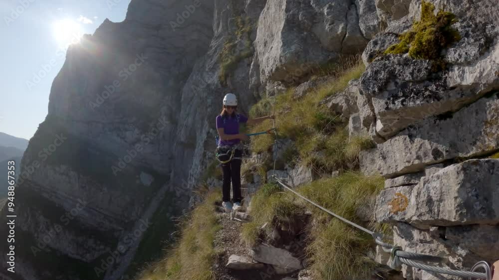 Female Rock Climber Climbing A Rock Wall Via Ferrata Female Rock Climber Climbing A Rock Wall Via Ferrata