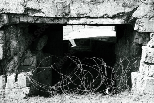 old abandoned german bunker in normandy coast with barbed wire, second world war
