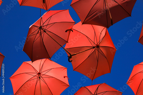 Colorful umbrellas under blue sky on the street in Albacete city