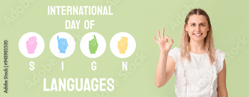 Young woman showing OK gesture on color background photo