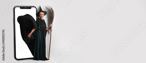 Mature witch with broom on ...