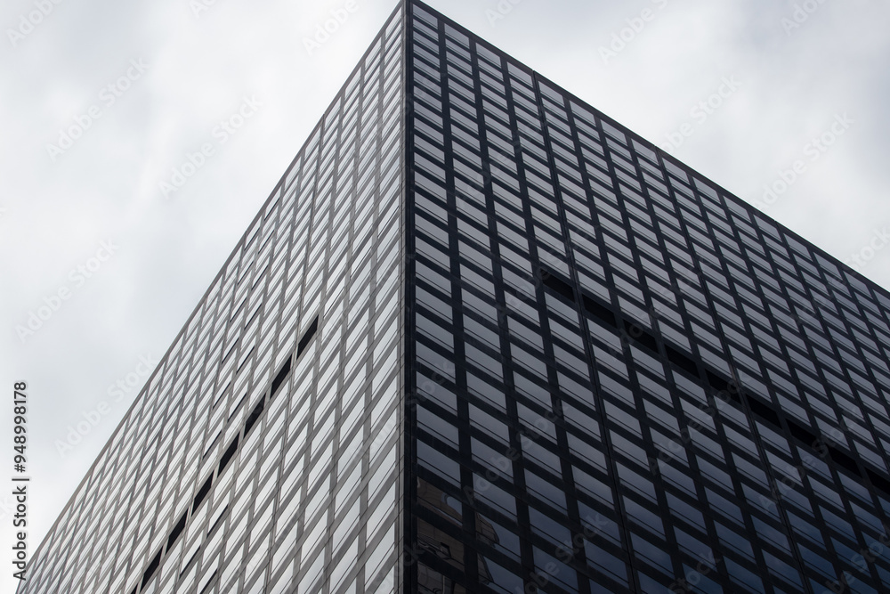 High rise office building against cloudy sky. New York city skyscraper under view. USA. High rise office building against cloudy sky. New York city skyscraper under view. USA.