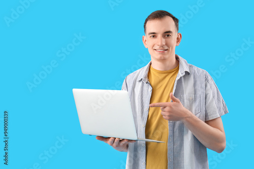 Young man pointing at lapto...