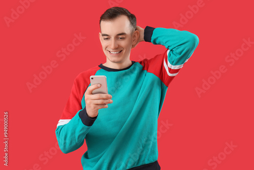 Young man with mobile phone...