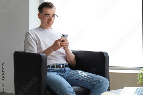 Young man with mobile phone...