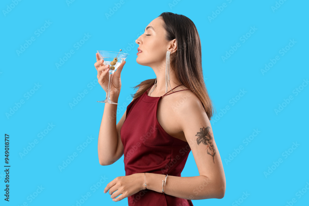Beautiful woman with martini on blue background Beautiful woman with martini on blue background