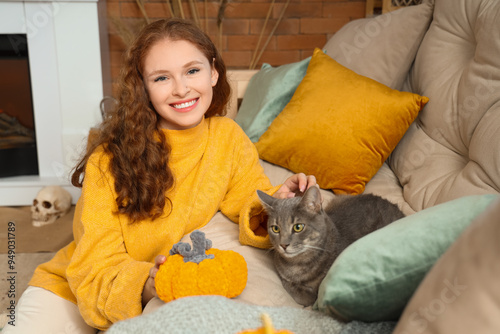 Young woman with cute cat a...