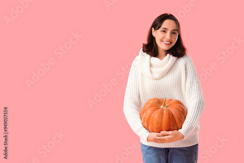 Young woman with pumpkin on...