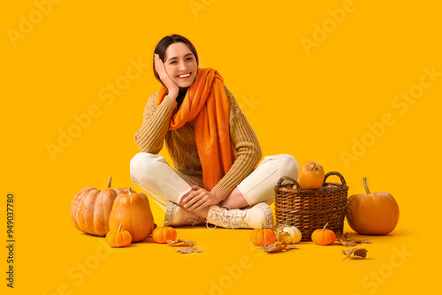 Young woman with pumpkins a...