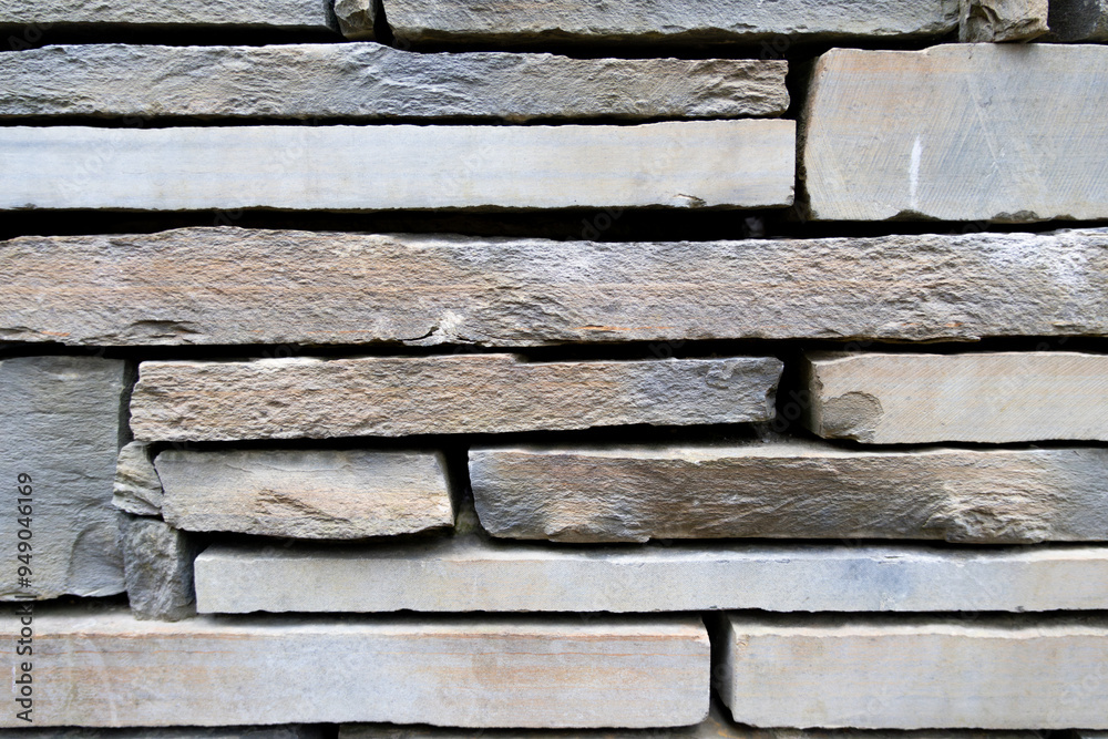 Light brown and grey stone wall with empty space in between. Beautiful stone pattern, background. Wallpaper Light brown and grey stone wall with empty space in between. Beautiful stone pattern, background. Wallpaper