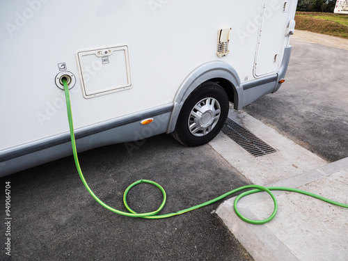 Motor home filling water tank and emptying grey water at the recharging point