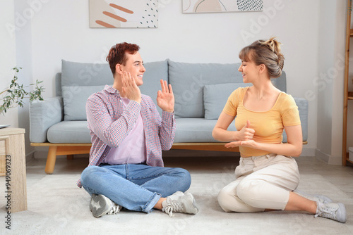 Young deaf mute couple usin...