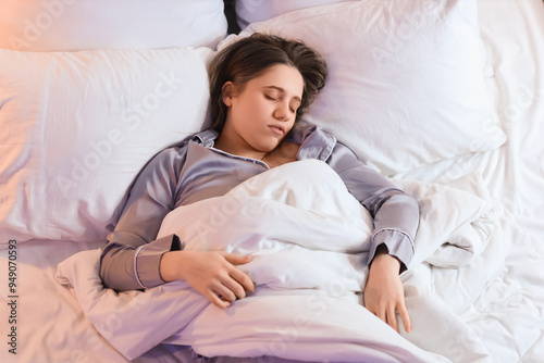 Young woman sleeping in bed...