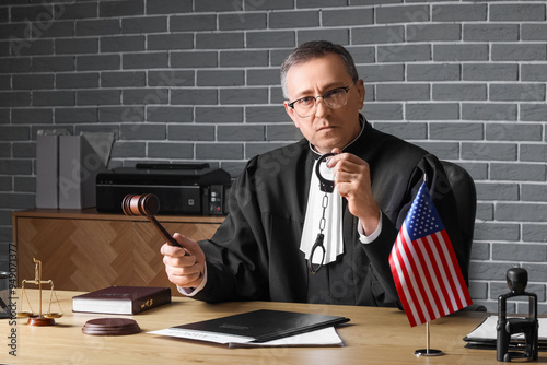 Mature judge with gavel and...