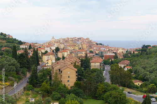 A Coastal Italian Town Nestled Amongst Green Hills on a Cloudy Day