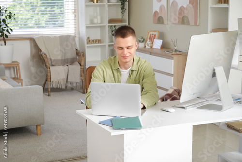 Young male freelancer worki...