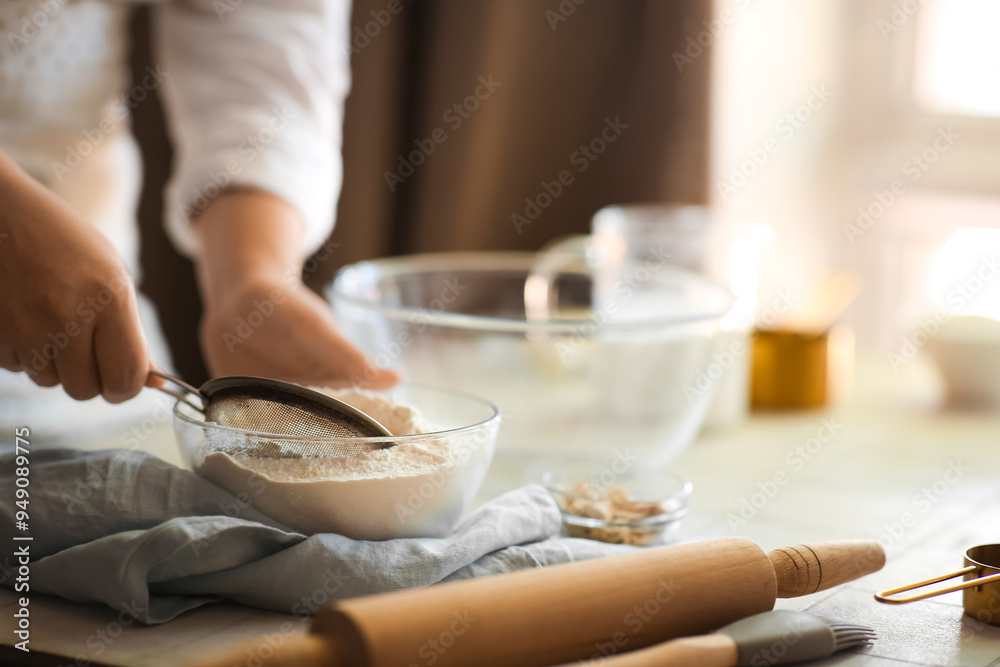 Woman preparing traditional cinnamon rolls in kitchen Woman preparing traditional cinnamon rolls in kitchen
