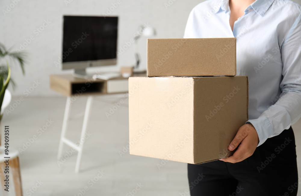 Businesswoman with cardboard boxes in office on moving day, closeup Businesswoman with cardboard boxes in office on moving day, closeup