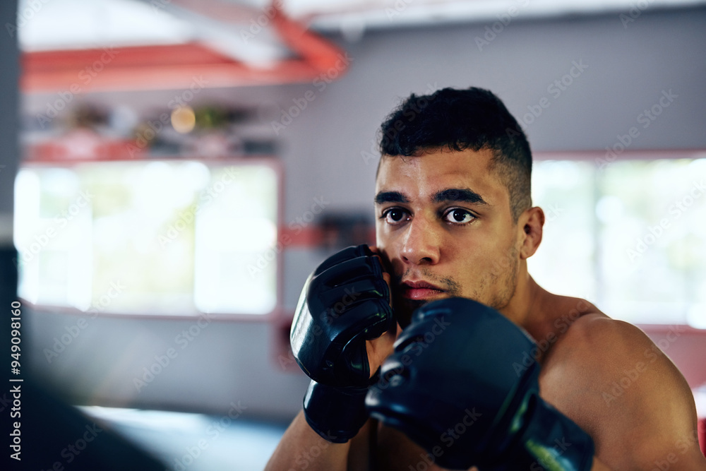Gym, man and serious on training with boxing for exercise or workout for competition. Male person, fitness and concentrate with sports or hobby on building muscle for tournament and challenge Gym, man and serious on training with boxing for exercise or workout for competition. Male person, fitness and concentrate with sports or hobby on building muscle for tournament and challenge