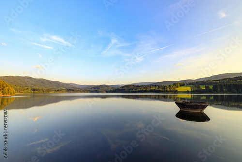 Evening at dam. Water-supply reservoir Nyrsko on Uhlava river in National Park Sumava. Source of drinking water. Sumava mountains visible on horizon. Czech Republic, Central Europe. photo