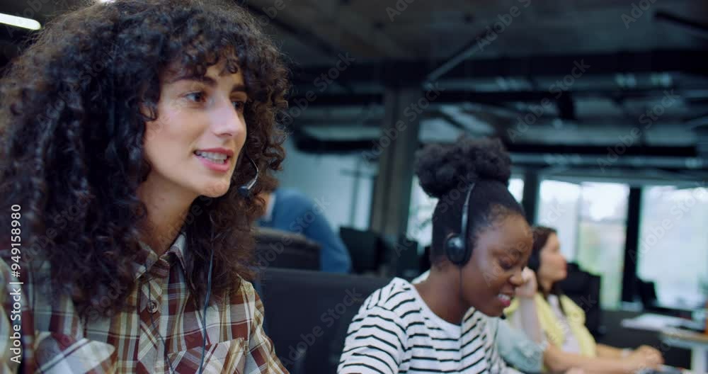 Pretty diverse women communicating with clients on headsets. Managers selling company products or informing about services. Having online conversation. Marketing concept. Using computers at work. Pretty diverse women communicating with clients on headsets. Managers selling company products or informing about services. Having online conversation. Marketing concept. Using computers at work.