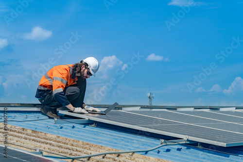 Worker Technicians are working to construct solar panels system on roof. Installing solar photovoltaic panel system. Men technicians walking on roof structure to check photovoltaic solar modules.