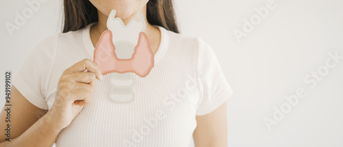 Woman holding Thyroid gland paper cutout, world thyroid day, thyroid cancer concept photo