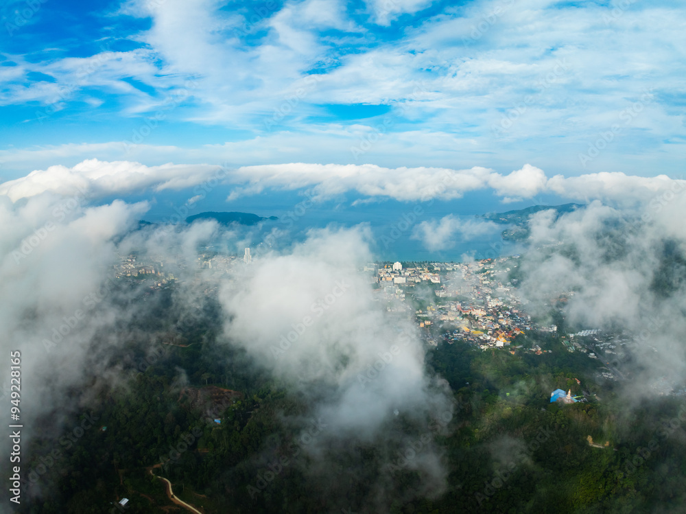 Aerial view of flowing fog waves on mountain tropical rainforest,Bird eye view image over the clouds Amazing nature background with clouds and mountain peaks in Thailand Aerial view of flowing fog waves on mountain tropical rainforest,Bird eye view image over the clouds Amazing nature background with clouds and mountain peaks in Thailand