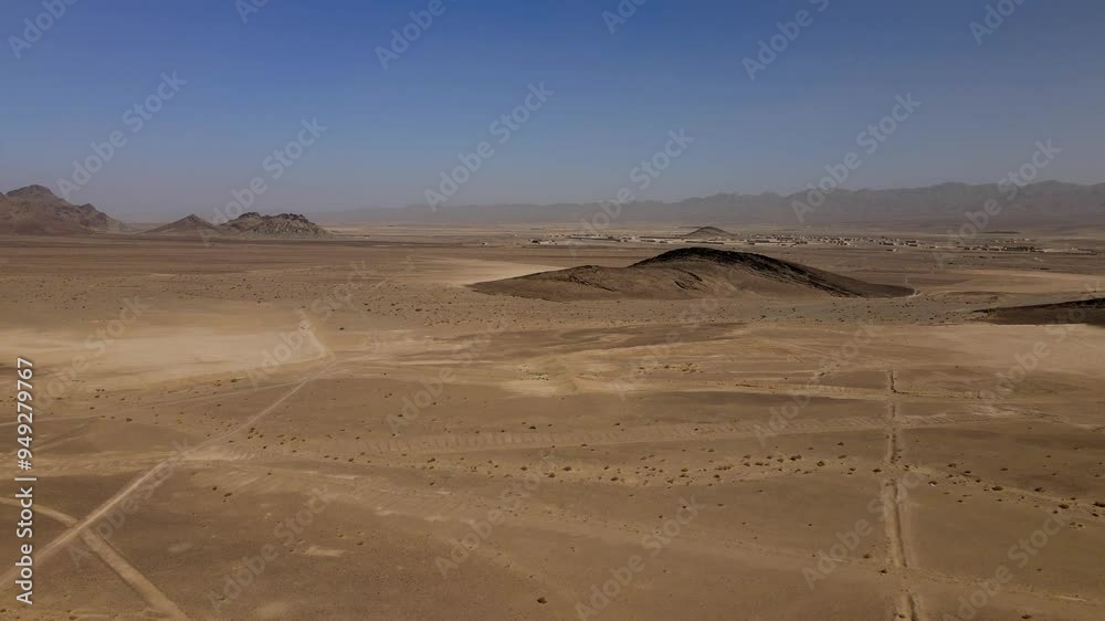 Aerial view of vast arid desert landscape with rugged mountains under clear sky, Panjgur District, Pakistan. Aerial view of vast arid desert landscape with rugged mountains under clear sky, Panjgur District, Pakistan.