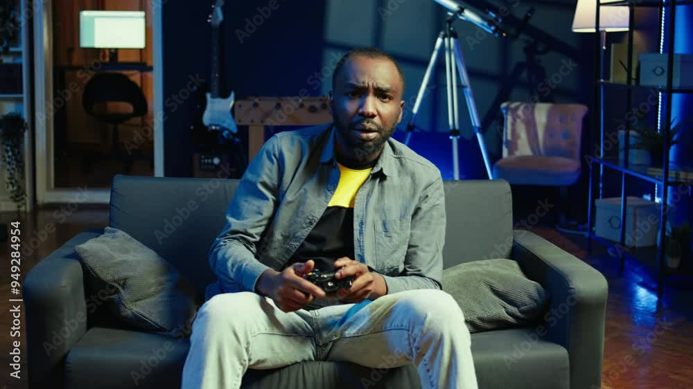 Gamer upset after losing while playing videogames on console system using controller. Man putting face in hands in frustration after being defeated playing games with gamepad, camera B Gamer upset after losing while playing videogames on console system using controller. Man putting face in hands in frustration after being defeated playing games with gamepad, camera B
