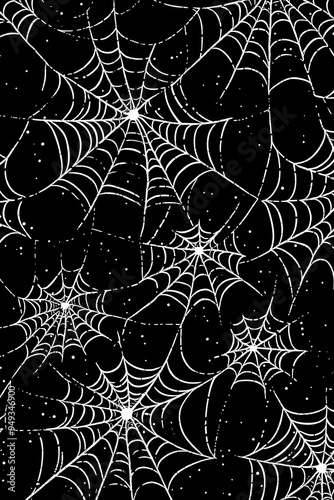 reepy white spider web of wild spider with tiny drops of water shining in light on black background. Scary cobweb for Halloween party. Closeup backdrop with copy space photo