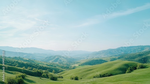 Rolling Green Hills Landscape Under Blue Sky with Clouds