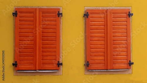 Tow windows with closed wooden shutters