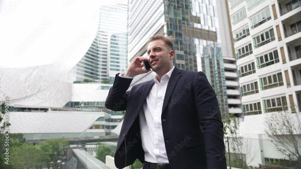 Skilled businessman talking to marketing team about marketing strategy by using phone while standing at skyscraper. Happy manager calling colleague about increasing sales at modern urban city. Urbane. Skilled businessman talking to marketing team about marketing strategy by using phone while standing at skyscraper. Happy manager calling colleague about increasing sales at modern urban city. Urbane.