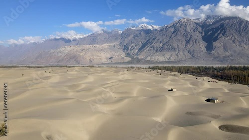 Aerial view of katpana desert with beautiful sand dunes and serene mountains under a vast sky, skardu, pakistan. photo