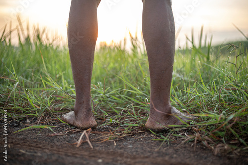 A man's feet are covered in mud and dirt.
