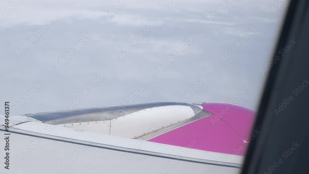 View from airplane aircraft window with airplane's wing and engine while flying in the sky with view of natural cloud sky outside.transportation vacation holiday travel background from plane window View from airplane aircraft window with airplane's wing and engine while flying in the sky with view of natural cloud sky outside.transportation vacation holiday travel background from plane window