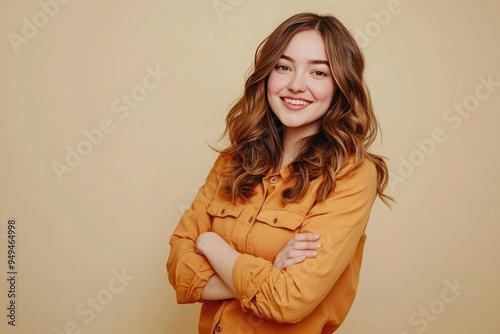 Side view young smiling Caucasian woman she wear orange shirt casual clothes hold hands crossed folded look camera isolated on plain pastel light beige background studio portrait. ai