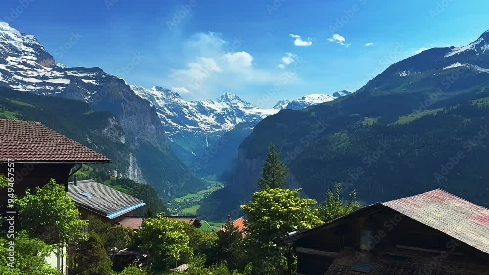 Timber Chalets Of Wengen Swiss Alpine Village In The Bernese Oberland, Switzerland. Aerial Panning Shot Timber Chalets Of Wengen Swiss Alpine Village In The Bernese Oberland, Switzerland. Aerial Panning Shot