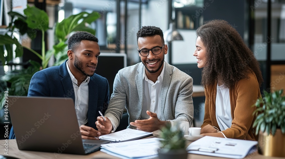 An insurance agent explaining life insurance options to a young couple in an office setting. An insurance agent explaining life insurance options to a young couple in an office setting.