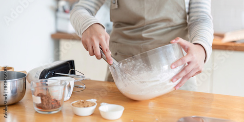 Close-up of mixing cake batter in modern kitchen setting photo