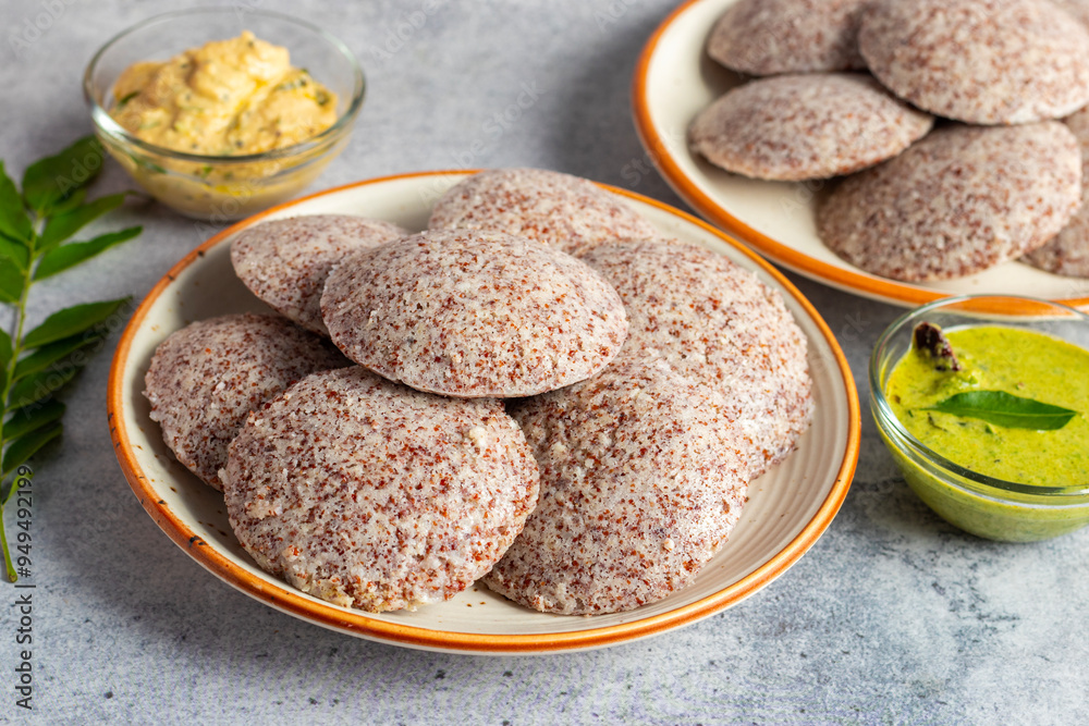 Selective focus of Soft, steamed Idli made from fermented ragi flour, rich in nutrients, perfect for a healthy breakfast. Selective focus of Soft, steamed Idli made from fermented ragi flour, rich in nutrients, perfect for a healthy breakfast.