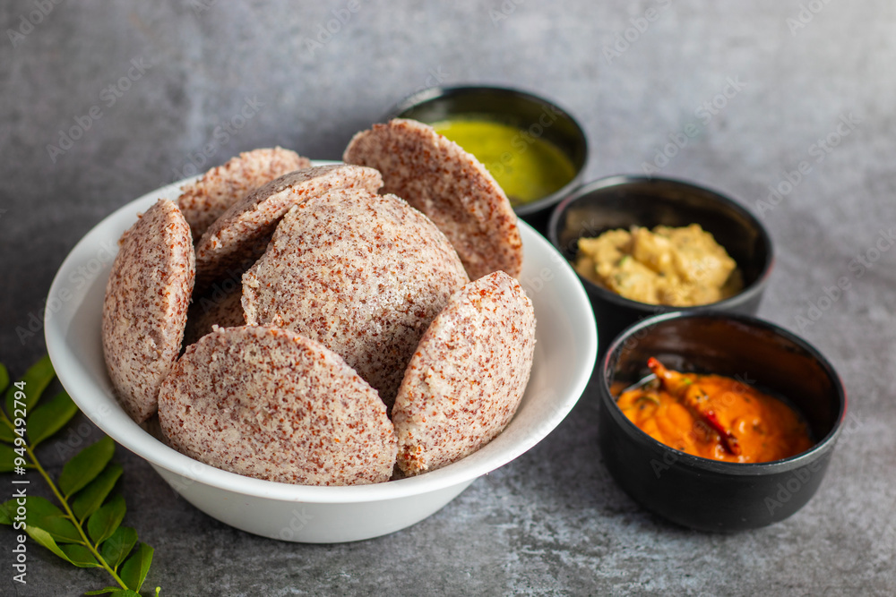 Selective focus of Soft, steamed Idli made from fermented ragi flour, rich in nutrients, perfect for a healthy breakfast. Selective focus of Soft, steamed Idli made from fermented ragi flour, rich in nutrients, perfect for a healthy breakfast.