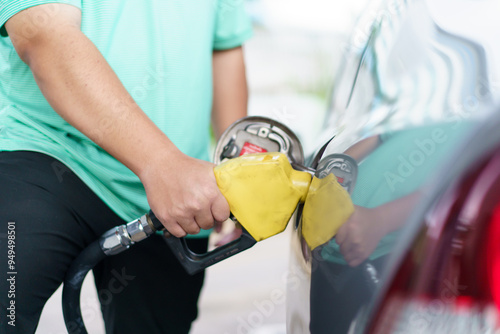 Asian man is refuels his car a gas. photo