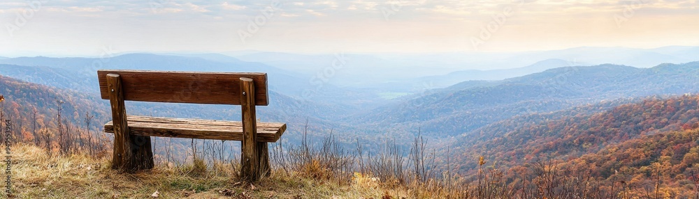 Rustic wooden bench overlooking vast autumn mountain landscape at sunset for peaceful reflection and gratitude
