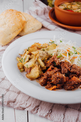 Delicious beef stew served with roasted potatoes and fresh coleslaw salad