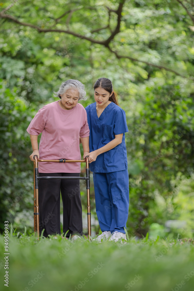 Elderly woman with walker carefully assisted by young nurse in a lush green park setting