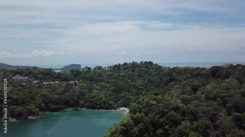 Aerial parallax shot revealing a hidden beach cove as well as Manuel Antonio National Park in Quepos, Costa Rica Aerial parallax shot revealing a hidden beach cove as well as Manuel Antonio National Park in Quepos, Costa Rica