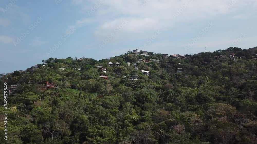 Tracking aerial shot of houses on a mountain in Costa Rica near Manuel Antonio Tracking aerial shot of houses on a mountain in Costa Rica near Manuel Antonio